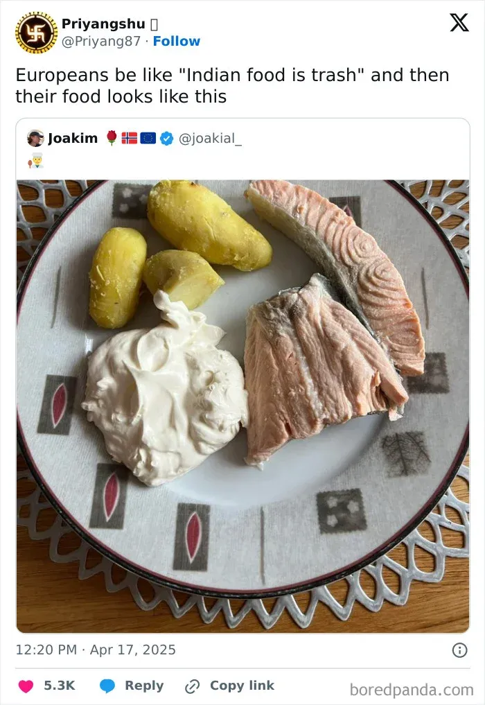 Boiled potatoes, salmon, and a large dollop of sour cream on a plate