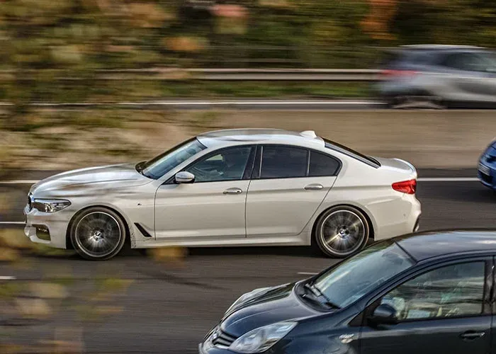 White car speeding dangerously on highway