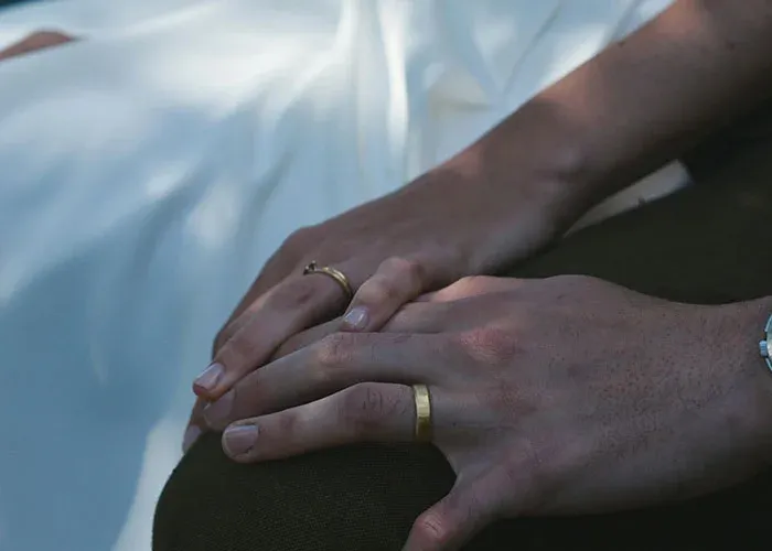 Couple's hands showing wedding rings symbolizing relationship commitment