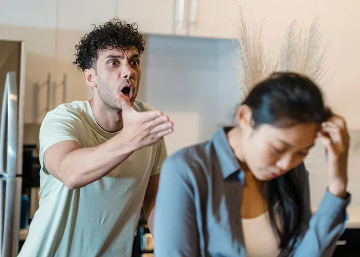 Couple arguing in kitchen during relationship strain