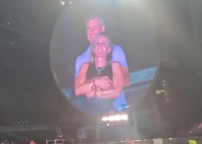 Couple embracing on stage under spotlight