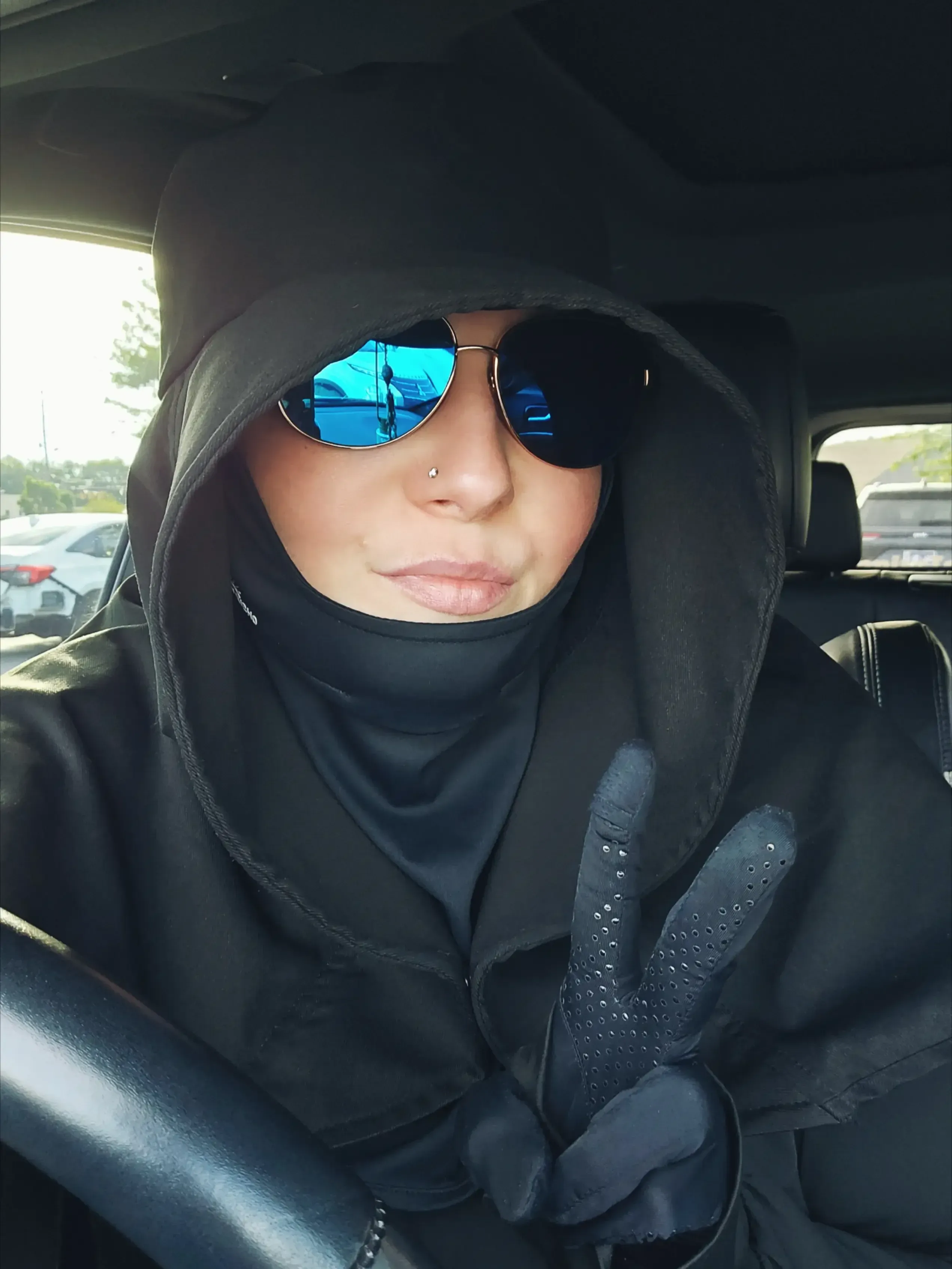 Emily wears full UV protection gear to safely leave her home.